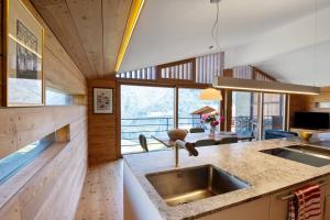 a kitchen with a sink and a living room at Chalet Oberjuval in Kastelbell-Tschars