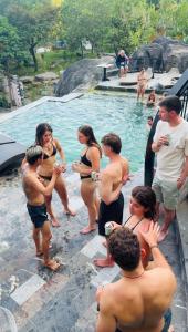 a group of people standing in a swimming pool at Lotus Premium Lodge in Ha Giang