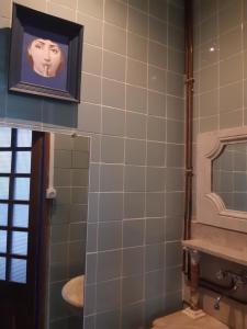 a bathroom with a picture of a face on the wall at Pan Demeure et Granges in Montesquieu-Avantès +170 photos