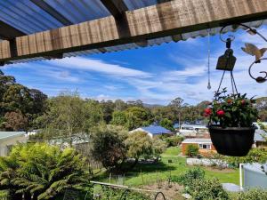 a view from the porch of a house with a flower pot at Stewarts Bay Retreat in Port Arthur