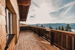 a wooden balcony with a view of the mountains at Radstädter Hütte am Rossbrand in Radstadt
