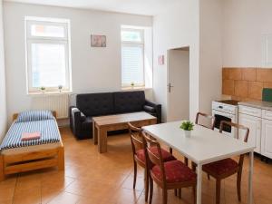 a kitchen and living room with a table and a couch at Apartmány Pražská in Ústí nad Labem