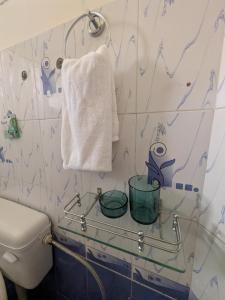 a bathroom with a toilet and a towel at Amore Holiday Home in Canacona