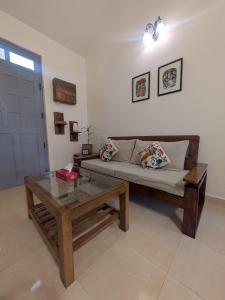 a living room with a couch and a coffee table at Amore Holiday Home in Canacona