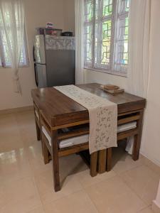 a wooden table in a kitchen with a refrigerator at Amore Holiday Home in Canacona +18 photos