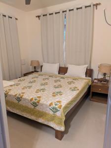 a bedroom with a bed with a quilt on it at Amore Holiday Home in Canacona