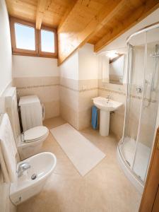 a bathroom with a toilet a sink and a shower at Residence Guardamar - Agenzia Cocal in Caorle +36 photos