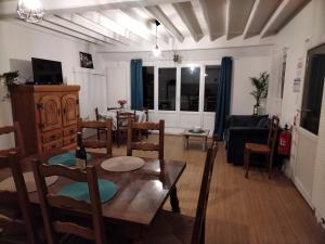 a living room with a table and chairs and a couch at Entre 2 Rives in Charly-sur-Marne