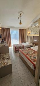 a hotel room with two beds and a window at Gazipasa Star Otel in Side +56 photos