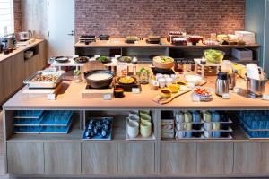 a kitchen with a buffet of food on a counter at たびのホテル佐渡Annex in Sado