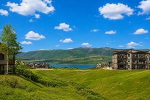 a view of a resort with a lake and mountains at Helling Circle Hideaway 303 in Heber City