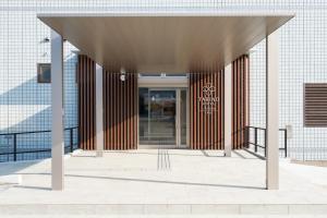 an entrance to a building with a glass door at たびのホテル佐渡Annex in Sado