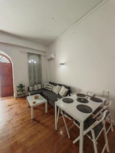 a living room with a couch and a table at Hidden Gem Convenient & Spacious in Andros