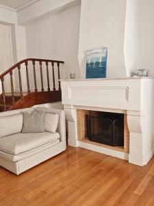 a living room with a fireplace and a couch at Hidden Gem Convenient & Spacious in Andros