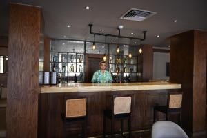 a man standing at a bar in a restaurant at Sharm Hills Elite Suite in Sharm El Sheikh