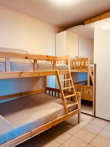 a room with three bunk beds in a room at Appartamento Mango in Cavallino-Treporti +24 photos