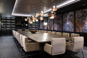 a dining room with a large wooden table and chairs at Hotel Restaurant Silberberg in Wolfsberg
