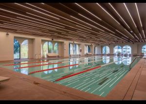 a large swimming pool with lanes in it at Suite Luxury Pipera and Spa in Bucharest