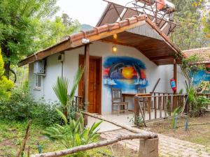 a house with a painting on the side of it at Atıcı 2 Hotel in Adrasan
