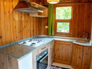 a kitchen with wooden cabinets and a stove top oven at Atıcı 2 Hotel in Adrasan +42 photos