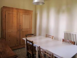 a dining room with a white table and chairs at Castello Sonnino in Montespertoli +36 photos