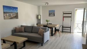 a living room with a couch and a table at Hotel garni SEESCHLÖSSCHEN in Kölpinsee