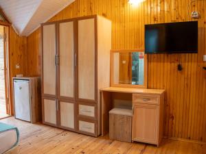 a room with a closet with a tv and a cabinet at Atıcı 2 Hotel in Adrasan