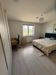 a bedroom with a bed and a desk and a window at En-suite Double Bedroom Adamstown in Lucan