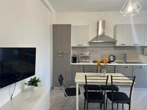 a kitchen and dining room with a table and chairs at Portunno Relax House in Fiumicino