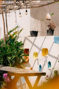 a patio with a table and some plants and a wall at Gió Homestay and Coffee in Ấp Khánh Phước (1)