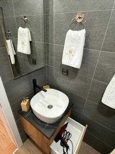 a bathroom with a white sink and a mirror at Misho Hills Retreat in Kopaonik +10 photos