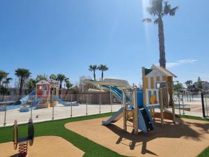 a playground in a park with a slide at Mobilhome élégance in Valras-Plage