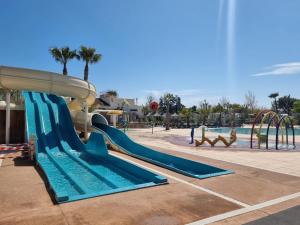 a water slide at a park with a pool at Mobilhome élégance in Valras-Plage