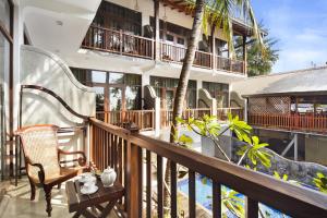 a balcony of a hotel with a table and a chair at Tartaruga Beach Unawatuna in Unawatuna