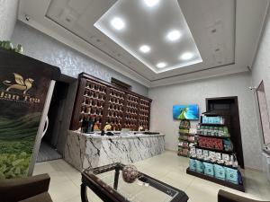 a wine store with a wine rack and a counter at Aslan Hostel in Samarkand