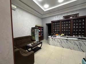 a wine tasting room with a couch and a counter at Aslan Hostel in Samarkand