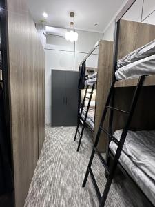 a room with three bunk beds and a closet at Aslan Hostel in Samarkand