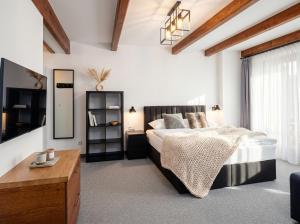 a bedroom with a large bed and a table at Golden Apartments - Villa Taternik - Tatry View in Zakopane