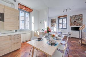 a kitchen and dining room with a table and chairs at Aparthotel Arona in Arona
