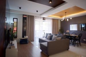 a living room with a couch and a table at Yanna's Unit - 3Bedroom with Breakfast in Baguio