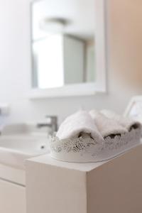 a white bathroom with a sink and a towel at Altes Winzerhaus Stegmann in Sankt Martin +56 photos