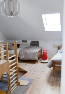 a bedroom with two beds and a skylight at Altes Winzerhaus Stegmann in Sankt Martin