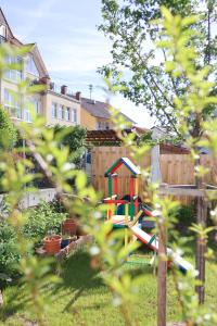 a playground in a yard with a fence at Altes Winzerhaus Stegmann in Sankt Martin