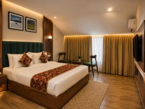 a hotel room with a bed and a television at The Countryside Resorts Pahalgam in Pahalgām