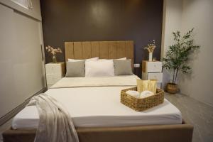 a bedroom with a large bed with a basket on it at Yanna's Unit - 3Bedroom with Breakfast in Baguio