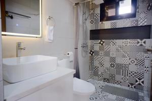a bathroom with a sink and a toilet and a shower at Yanna's Unit - 3Bedroom with Breakfast in Baguio +45 photos