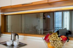 a bowl of fruit on a counter in front of a mirror at Piazzetta Lake View by Halldis in Dongo +32 photos
