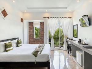 a bedroom with a large white bed and a kitchen at Villa Agati in Siem Reap +50 photos