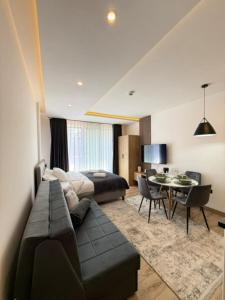 a living room with a bed and a dining room at Misho Hills Retreat in Kopaonik