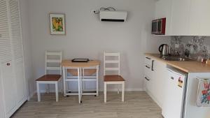 a kitchen with a table and a small table in it at Amblers Rest Accomodation in Drury